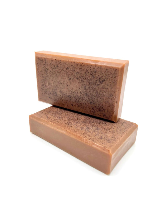 Two chocolate brown colored soap bars with beveled edges. 